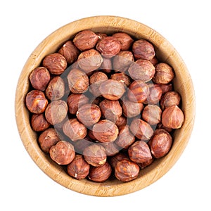 Hazelnuts in wooden bowl isolated on white. Top view