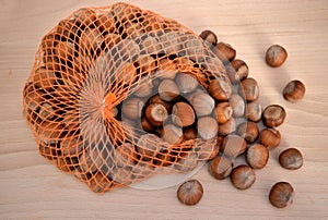 Hazelnuts on a wooden table and net