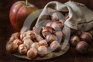 hazelnuts in a woven bag and other fruits