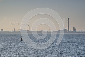 Hazy evening view of Dublin Waste to Energy Covanta Plant, Poolbeg CCGT and Pigeon House Power Station view from Dun Laoghaire