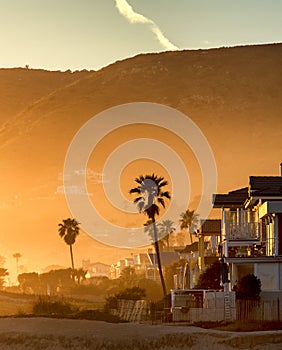 Hazy golden sunset on Malibu beach, California.