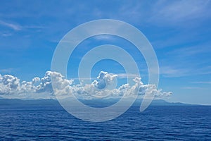 The hazy and mountainous coastline of the Caribbean Island of Haiti as a cruise ship sails by