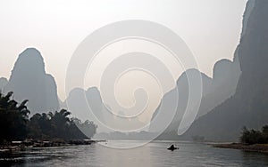 A hazy scene along the Li River between Guilin and Yangshuo in Guangxi Province, China