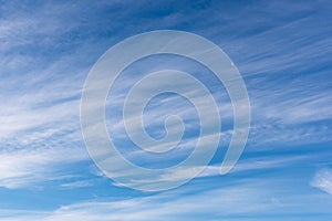 Hazy small cirrostratus, cirrocumulus and cumulus cloud formations at blue sky