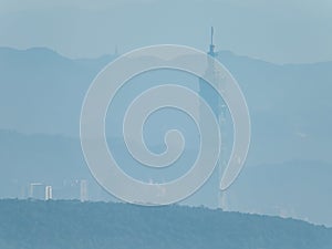 Hazy view of the Taipei 101 and cityscape from a far mountain