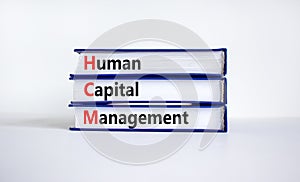 HCM, Human capital management symbol. Concept words HCM, Human capital management on books on a beautiful white background.