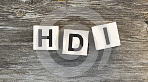 HDI text on wooden block on wooden background
