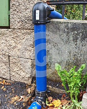 HDPE blue tube connected by bent part to city drinking water supply system