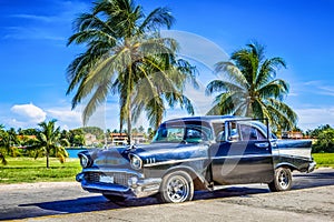 HDR - American black vintage car parked under palms near the beach in Varadero Cuba - Serie Cuba Reportage