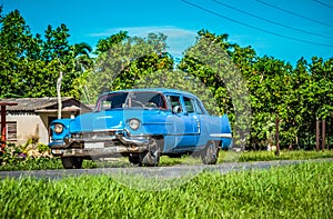 HDR - American blue classic car on the country road in Santa Clara - Serie Cuba Reportage