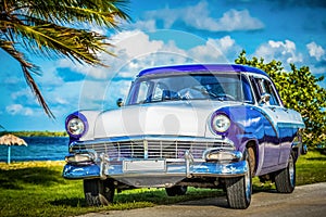 HDR - American blue classic car parked on the Malecon near the beach in Havana Cuba - Serie Cuba Reportage