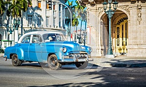 HDR - American blue classic car with white roof drived on the main street in Havana City Cuba - Serie Cuba Reportage