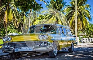 HDR - American golden Ford Brookwood parked under palms near the beach in Varadero Cuba - Serie Cuba Reportage