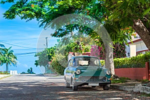 HDR - American green classic car parked in the side street from Varadero Cuba - Serie Cuba Reportage