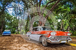 HDR - American red and blue classic car parked in the province Santa Clara in Cuba - Serie Cuba Reportage