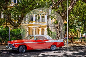 HDR - American red classic car with white roof parked on the side street in Havana Cuba - Serie Cuba Reportage