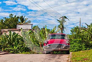 HDR - American red vintage car parked in the side street in Santa Clara Cuba - Serie Cuba Reportage