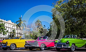 HDR - Beautiful american convertible vintage cars parked in series in Havana Cuba before the gran teatro - Serie Cuba Reportage