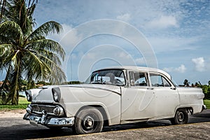 HDR Cuba white american classic car parked under blue sky in varadero