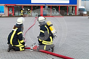 HDR - firefighter in action with waterhose