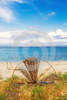 HDR image of a broken umbrella on the beach in Hanioti