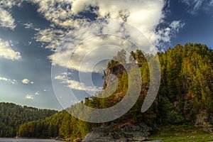 The HDR image of rocks with pine forest and blue sky