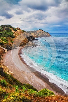 HDR image of a secluded beach on Skiathos island on a cloudy day