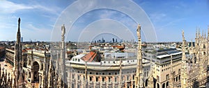 HDR panorama photo of marble statues of Cathedral Duomo di Milano on piazza, Milan cityscape and Galleria Vittorio Emanuele II