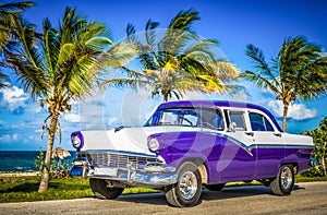 HDR - Parked american white blue vintage car in the front-side view on the beach in Havana Cuba - Serie Cuba Reportage