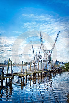 HDR photo of shrimp boats on a dock.