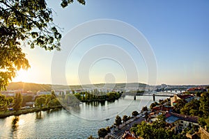 HDR photo of a view on Vltava river with sun setting behind it from Vysehrad in Prague, Czech republic