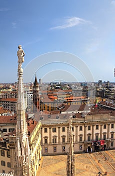 HDR photo of the white marble statues of Cathedral Duomo di Milano on piazza, Milan cityscape and the Royal Palace of Milan