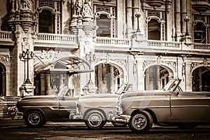 HDR - Street life with parked american convertible vintage cars before the gran teatro in Havana Cub