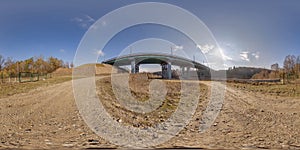 hdri 360 panorama on gravel road near steel frame construction of huge car bridge across river in equirectangular full seamless