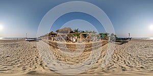 360 hdri panorama with coconut trees on ocean coast near tropical shack or open air cafe on beach with fence in equirectangular