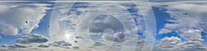 360 hdri panorama in equirectangular format of blue skydome and haze clouds with flock of birds for use in 3d graphics or game photo