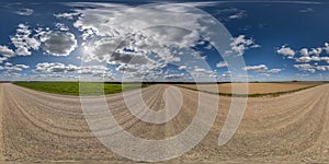 360 hdri panorama on white sand gravel road with clouds on blue sky in equirectangular spherical seamless projection, skydome photo