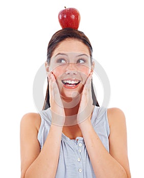 Head balance, face and happy woman with apple fruit product to lose weight, diet or detox for wellness lifestyle. Vegan