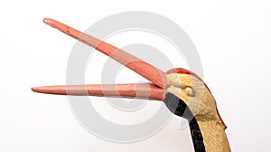 The head and beak of a stork bird made of wood on a white background, isolate. Close-up