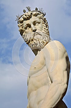 The head and body of Neptune against a blue sky
