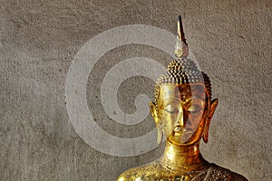 Head of Buddha image with gold leaf on face.