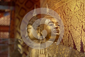 Head of Buddha statue with yellow light in Temple of Thailand. Golden buddha statue in temple of Thailand