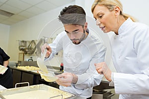 head chef with apprentice in kitchen