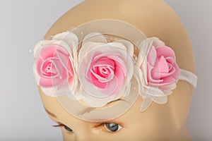 Head of child mannequin with bandage for girls on white background.