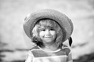 Head close up. Close up head shot of child in straw hat. Kids face, little boy portrait.