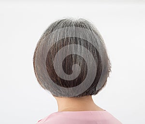 Head of elderly woman tranforming to grey hair, from behind