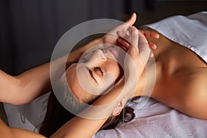 Head and face massage in spa salon