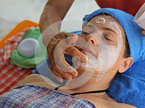 Head face thai massage woman with closed eyes and massaging hands