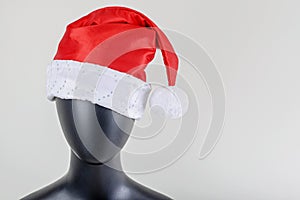A head of female mannequin with santa claus hat isolated on white background.