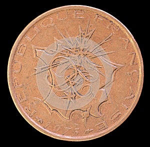 Head of 10 francs coin, issued by France in 1975 depicting a map of metropolitan France with flashes pointing to Paris photo